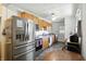 Galley kitchen with stainless steel appliances, wooden cabinets, and space for a dining table at 7307 Twin Beech Dr, Indianapolis, IN 46226