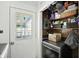 Functional laundry area with washer, shelving, and convenient access to the exterior via a door with glass panels at 7307 Twin Beech Dr, Indianapolis, IN 46226