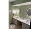 Bathroom featuring dual sinks, framed mirrors, and sage green walls at 7334 Fairwood Cir, Indianapolis, IN 46256