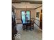 Formal dining room features classic chandelier, light walls, carpet and dark wood trim at 7334 Fairwood Cir, Indianapolis, IN 46256