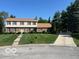 Charming two-story home featuring a well-maintained lawn and inviting curb appeal at 7334 Fairwood Cir, Indianapolis, IN 46256