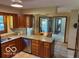 Warm, inviting kitchen offers granite counters, wood cabinetry, stainless dishwasher and eat-in space at 7334 Fairwood Cir, Indianapolis, IN 46256
