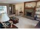 Relaxing living room includes brick fireplace, built-in shelves, and sliding glass door at 7334 Fairwood Cir, Indianapolis, IN 46256