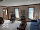 Bright living room features neutral carpet, light walls, traditional furnishings, and large windows at 7334 Fairwood Cir, Indianapolis, IN 46256