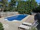 In-ground pool with diving board, surrounded by lounge chairs and privacy fencing at 7334 Fairwood Cir, Indianapolis, IN 46256