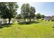 Expansive backyard featuring a lake view with a dock and lush greenery at 7567 Muirfield Pl, Indianapolis, IN 46237