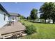 Outdoor deck offers stunning views of the well-maintained backyard leading to a serene lake at 7567 Muirfield Pl, Indianapolis, IN 46237