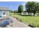 Wooden deck providing scenic views of the lush backyard extending towards the tranquil lake at 7567 Muirfield Pl, Indianapolis, IN 46237