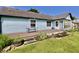Back of light blue house featuring a wooden deck, perfect for enjoying the landscaped yard at 7567 Muirfield Pl, Indianapolis, IN 46237