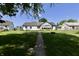 Well-maintained backyard with a brick pathway leading to the home and a fire pit at 7567 Muirfield Pl, Indianapolis, IN 46237