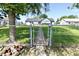 Backyard of a home featuring a brick pathway leading through a metal gate and to the house at 7567 Muirfield Pl, Indianapolis, IN 46237