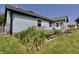 Back of house with a wooden deck and surrounding flower beds, ideal for outdoor enjoyment at 7567 Muirfield Pl, Indianapolis, IN 46237
