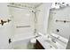 Bright bathroom featuring a white vanity, toilet, and bathtub with tiled shower and grab bar for accessibility at 7567 Muirfield Pl, Indianapolis, IN 46237