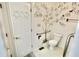 Accessible bathroom featuring safety grab bars and decorated walls at 7567 Muirfield Pl, Indianapolis, IN 46237