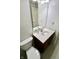Bathroom featuring a white vanity with a wood cabinet, mirror, toilet and seashell wallpaper at 7567 Muirfield Pl, Indianapolis, IN 46237