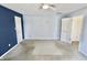 Bedroom featuring fresh carpet and ceiling fan, with a painted accent wall at 7567 Muirfield Pl, Indianapolis, IN 46237