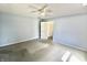Neutral bedroom featuring ceiling fan, fresh carpet, and a view to hallway at 7567 Muirfield Pl, Indianapolis, IN 46237