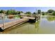 Wooden dock on a calm lake with 'No Trespassing' sign, offering privacy and scenic views at 7567 Muirfield Pl, Indianapolis, IN 46237
