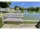 Lake view from the dock, with peaceful waters and neighboring houses nestled among lush greenery at 7567 Muirfield Pl, Indianapolis, IN 46237