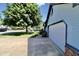 Home with a blue exterior, complemented by a wide driveway, landscaped yard, and attached garage at 7567 Muirfield Pl, Indianapolis, IN 46237