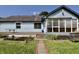 Charming home exterior with a sunroom, deck, and landscaped backyard at 7567 Muirfield Pl, Indianapolis, IN 46237