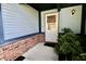 Inviting front entrance with brick detail, blue siding, and well-maintained landscaping at 7567 Muirfield Pl, Indianapolis, IN 46237