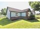 Charming, single-story home with blue siding, brick accents, well-maintained landscaping, and an attached garage at 7567 Muirfield Pl, Indianapolis, IN 46237