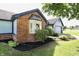 Charming, single-story home with blue siding, brick accents, well-maintained landscaping, and an attached garage at 7567 Muirfield Pl, Indianapolis, IN 46237