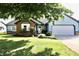 Charming, single-story home with blue siding, brick accents, well-maintained landscaping, and an attached garage at 7567 Muirfield Pl, Indianapolis, IN 46237