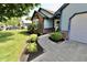 Charming, single-story home with blue siding, brick accents, well-maintained landscaping, and a concrete walkway at 7567 Muirfield Pl, Indianapolis, IN 46237