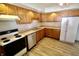 Kitchen showcasing wood cabinets, stainless steel appliances, and modern flooring at 7567 Muirfield Pl, Indianapolis, IN 46237