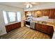 Bright kitchen featuring wood cabinets, stainless steel appliances, and a bay window at 7567 Muirfield Pl, Indianapolis, IN 46237