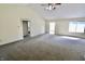 Open living room with high ceilings, a ceiling fan, and natural light at 7567 Muirfield Pl, Indianapolis, IN 46237