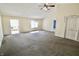 Large living room with carpet and multiple doorways for easy access to the rest of the house at 7567 Muirfield Pl, Indianapolis, IN 46237