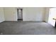Neutral living room with carpet, multiple doorways, and connections for media at 7567 Muirfield Pl, Indianapolis, IN 46237