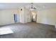 Spacious living room with vaulted ceiling, ceiling fan, and doorways trimmed with floral accents at 7567 Muirfield Pl, Indianapolis, IN 46237