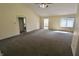 Bright living room features vaulted ceilings, ceiling fan, and ample sunlight at 7567 Muirfield Pl, Indianapolis, IN 46237