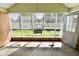 Sun-drenched sun room with multiple windows, a view of the garden, and access to the backyard at 7567 Muirfield Pl, Indianapolis, IN 46237