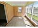 Bright sunroom featuring wood paneling, large windows, and a view of the backyard at 7567 Muirfield Pl, Indianapolis, IN 46237