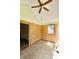 Angle view of sunroom featuring wood paneling, ceiling fan, and plenty of natural light at 7567 Muirfield Pl, Indianapolis, IN 46237