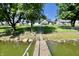 Charming light blue home with direct access to a serene lake from a wooden pier and fenced yard at 7567 Muirfield Pl, Indianapolis, IN 46237