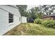 Spacious backyard featuring a shed, and an extension of the home's white brick exterior at 7719 Grandview Dr, Indianapolis, IN 46260