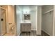 Modern bathroom featuring a vanity with sink, contemporary mirror and lighting, closet and neutral color palette at 7719 Grandview Dr, Indianapolis, IN 46260