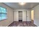Cozy bedroom with wood-look floors, abundant natural light, and a spacious closet, offering a comfortable retreat at 7719 Grandview Dr, Indianapolis, IN 46260