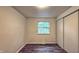 Comfortable bedroom featuring wood-look floors, ample natural light, and a closet providing functionality and style at 7719 Grandview Dr, Indianapolis, IN 46260