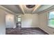 Bright and airy bedroom with wood-look floors, exposed beams, and abundant natural light streaming through the windows at 7719 Grandview Dr, Indianapolis, IN 46260