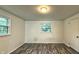 Bright bedroom featuring laminate flooring, dual windows offering natural light, and a clean, neutral palette at 7719 Grandview Dr, Indianapolis, IN 46260