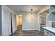 Cozy dining area with a modern light fixture, pantry closet, wood-look flooring, and bright, neutral walls at 7719 Grandview Dr, Indianapolis, IN 46260