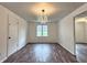 Well-lit dining room featuring wood-look floors, ample natural light, and an elegant chandelier at 7719 Grandview Dr, Indianapolis, IN 46260
