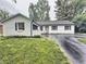Charming single-story home with a freshly painted white exterior and inviting curb appeal in a well-maintained yard at 7719 Grandview Dr, Indianapolis, IN 46260